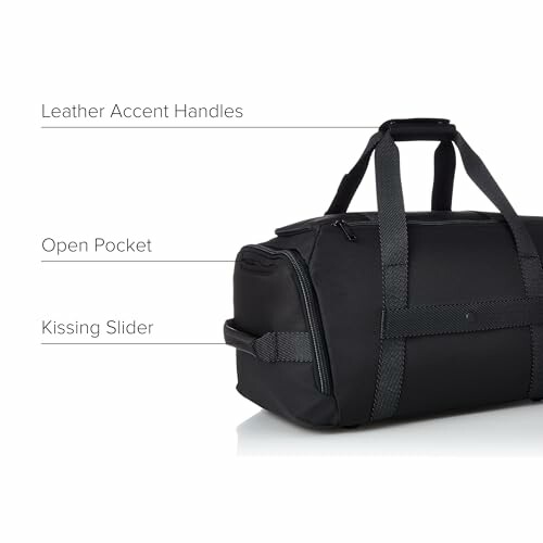 Black duffel bag with leather accent handles, open pocket, and kissing slider.
