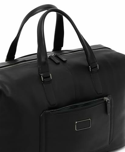Black leather duffel bag with handles and front pocket.