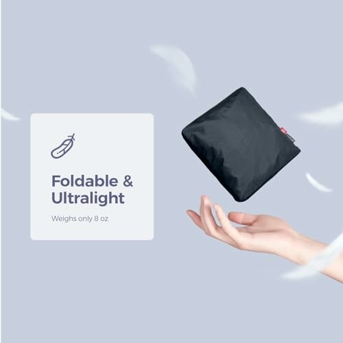 Foldable ultralight bag, weighs 8 oz, hand holding compact item.