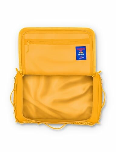 Open yellow backpack showing interior pockets and lining.