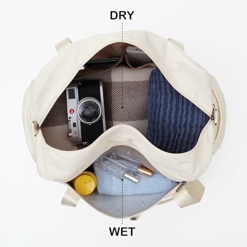 Open travel bag with dry and wet compartments, containing a camera, towel, and toiletries.