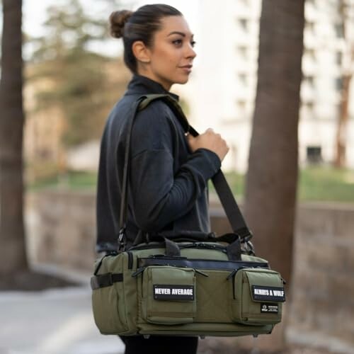 Woman carrying a green gym bag outdoors.